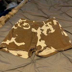 Asymmetrical cow print denim shorts